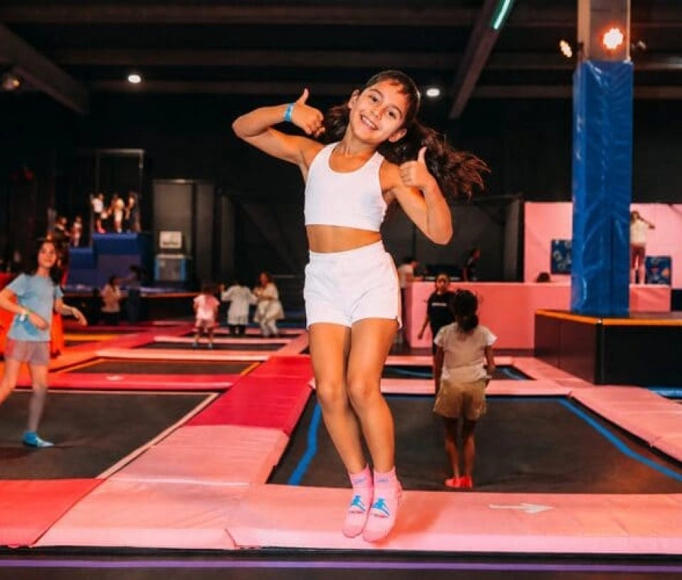 fille trampoline park qui fait un grand sourire